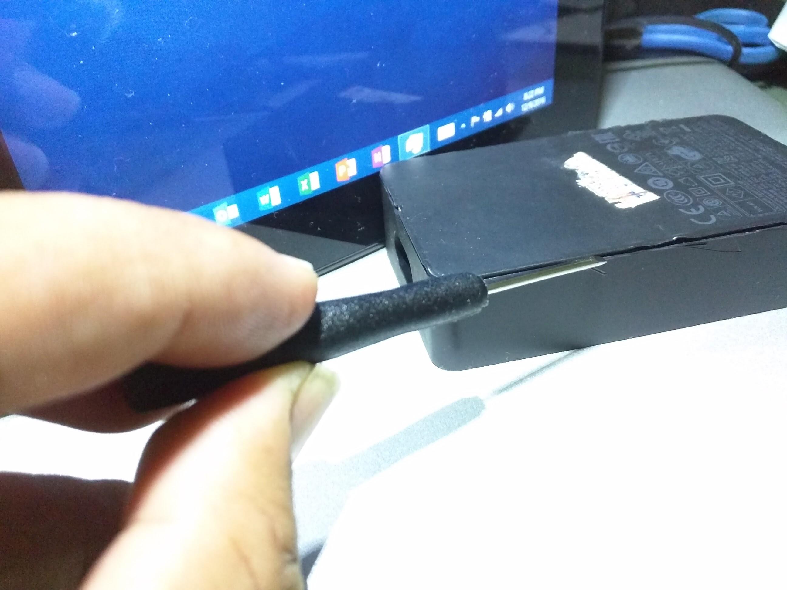 Use a Flat-Head Screwdriver to separate the Surface charger's cover